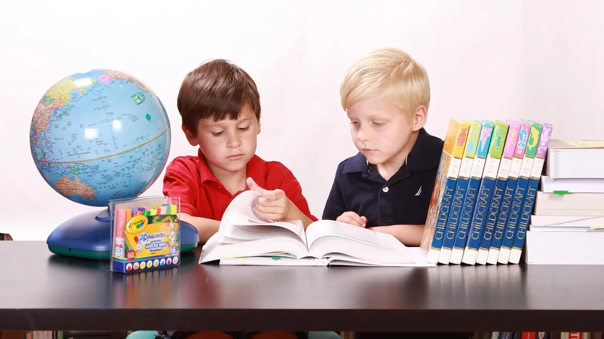 children, studying, togetherness, boys, reading, books, students, learning, educational, materials, globe, wooden, table, brown, desk, school, rooms, houses, homes, inside, indoors, interior, sitting, looking down, brothers, siblings, friends, friendship, childhood, innocent, innocence, young, people, two, person, little, small, kids, students, students, globe, school, school, school, school, school
